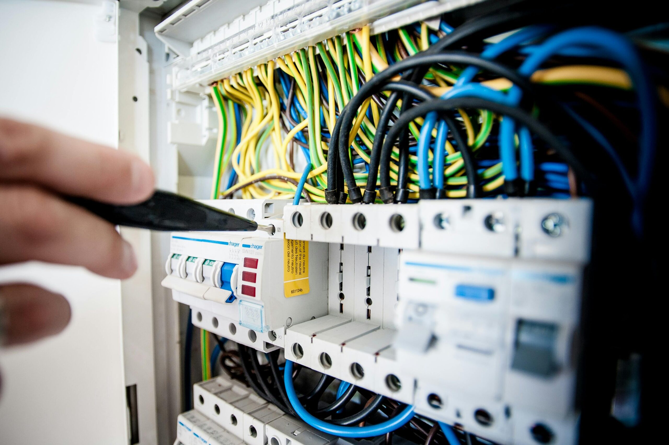 Certified electrician working on electrical distribution panel